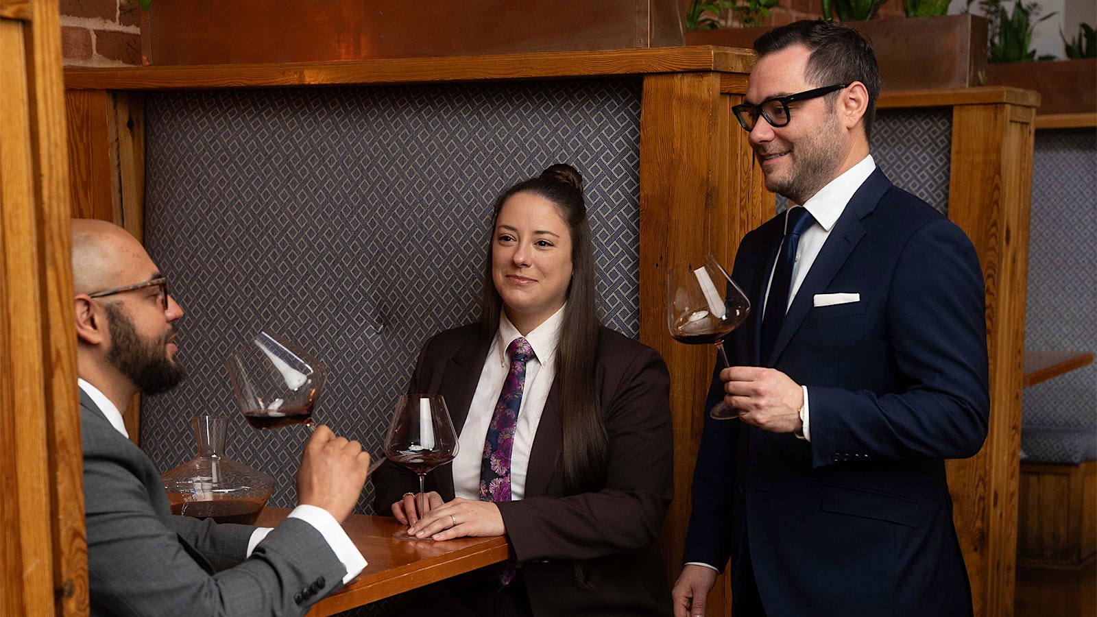 Three members of the Soby’s wine team—from left, sommelier Robert Chambers, assistant wine director Cait Bryan and sommelier Matt Seitz—in a dining-room booth